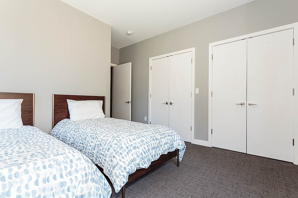 17 Ash Street Waltham, MA 02453 - Photo 10 of 32 a bedroom with two bed and a night lamp