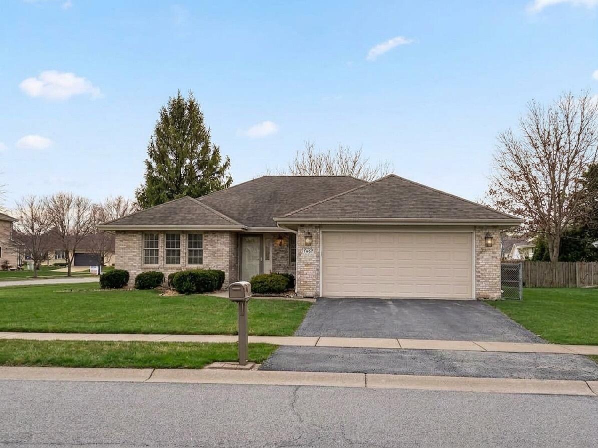 2962 Liberty Drive Crown Point, IN 46307 - Photo 1 of 18 a front view of a house with a yard and potted plants