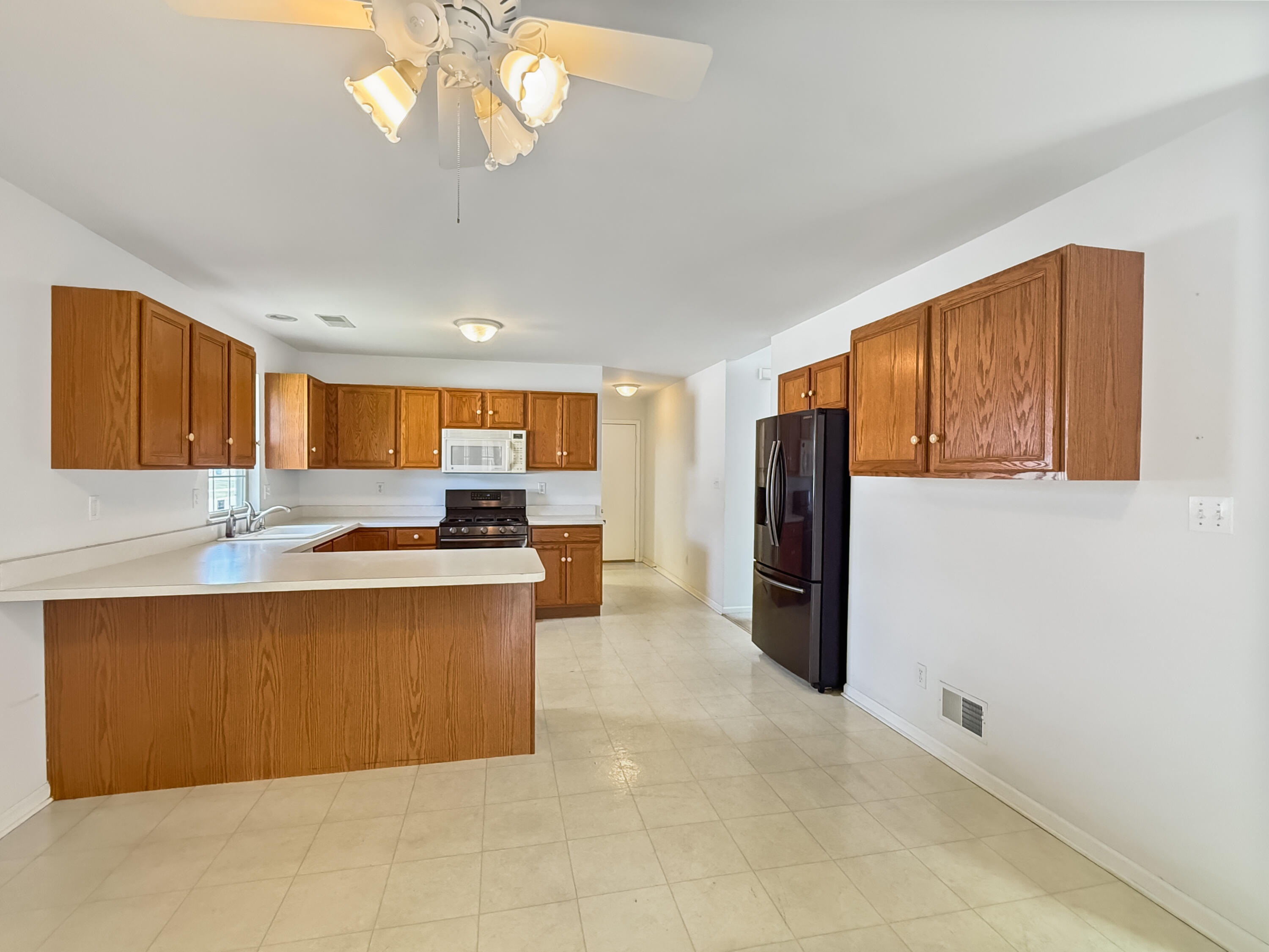 2962 Liberty Drive Crown Point, IN 46307 - Photo 3 of 18 a large kitchen with stainless steel appliances granite countertop a refrigerator and a sink