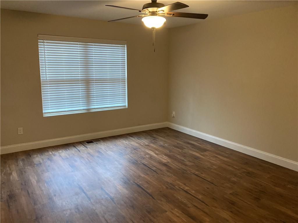 3780 Highway 52 Dahlonega, GA 30533 - Photo 11 of 19 a view of an empty room with wooden floor and a window