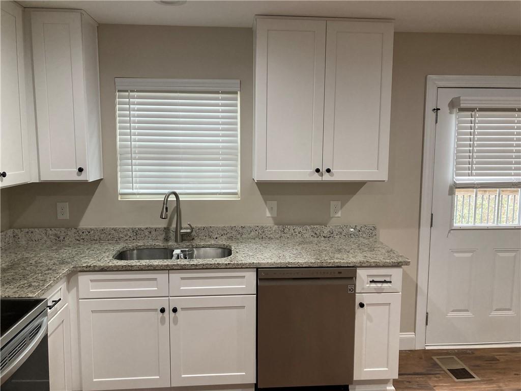 3780 Highway 52 Dahlonega, GA 30533 - Photo 6 of 19 a kitchen with granite countertop white cabinets and a sink