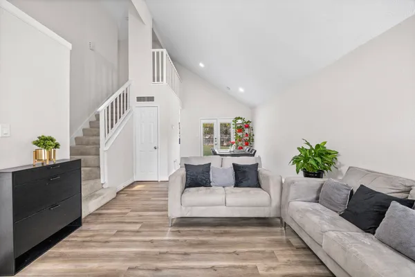 a living room with furniture and wooden floor