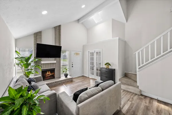 a living room with furniture a flat screen tv and a fireplace