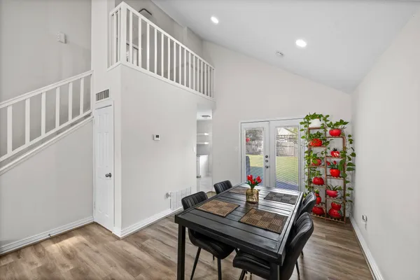 a view of a dining room with furniture wooden floor and a potted plant