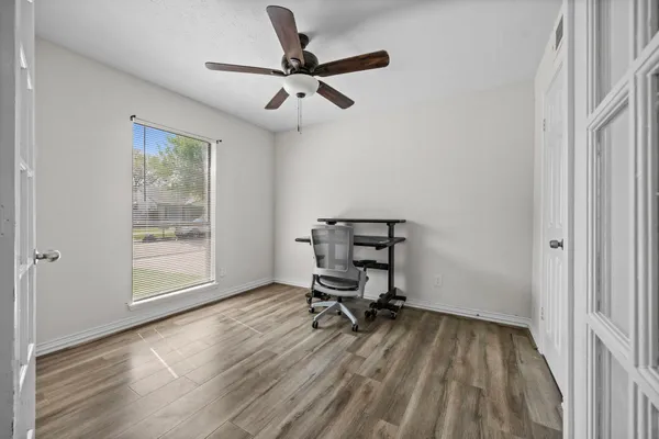 a view of room with a window and wooden floor