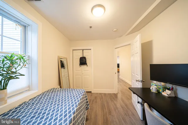 a bedroom with a bed and a flat screen tv