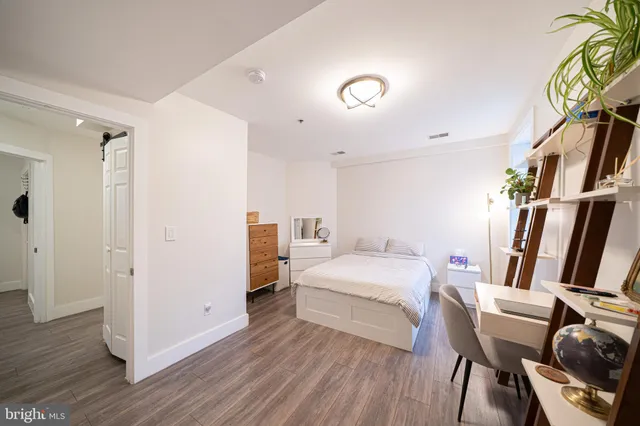 a bed room with a bed and a chair