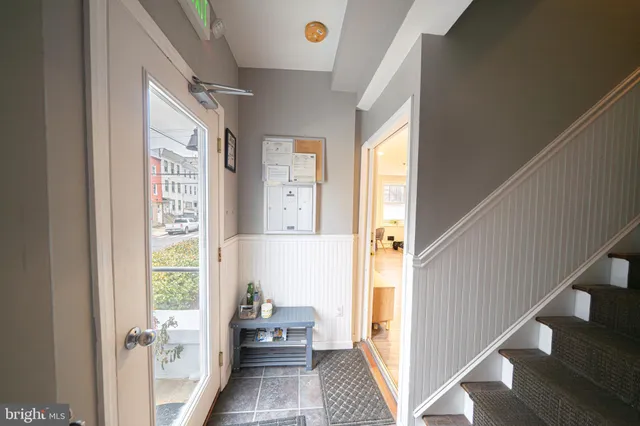 a view of a hallway with windows and stairs