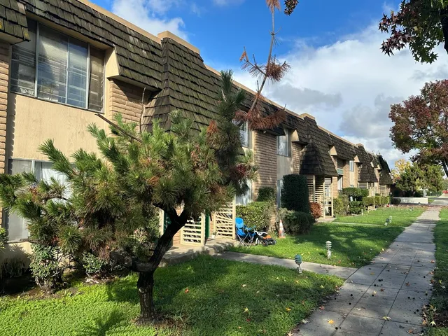 a tall building with trees in front of it