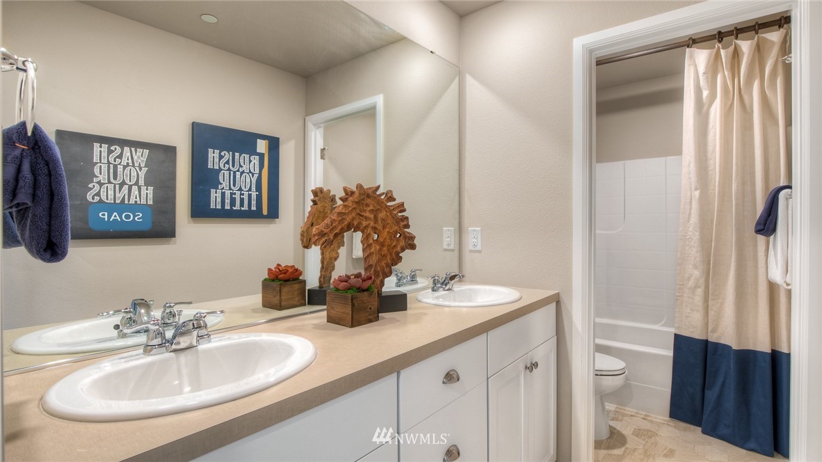 1376 Baker Hts Loop Bremerton, WA 98312 - Photo 17 of 19 a bathroom with a double vanity sink and a mirror