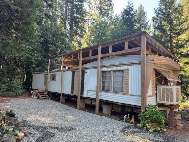 a view of a house with a yard and balcony