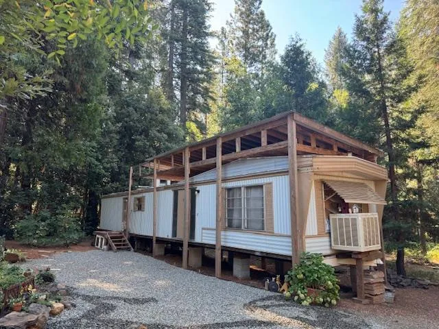 a view of a patio with table and chairs with wooden floor and fence