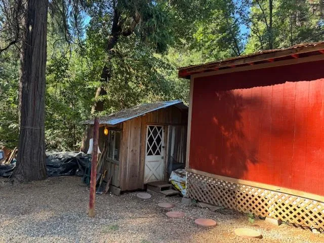 a backyard of a house with table and chairs