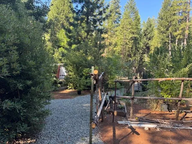 a backyard of a house with table and chairs