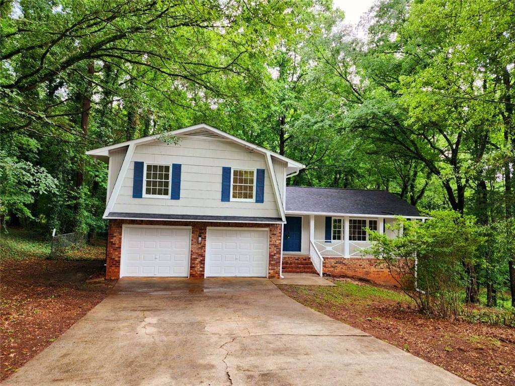 3467 Albatross Court Decatur, GA 30034 - Photo 1 of 1 a front view of a house with a garden and trees