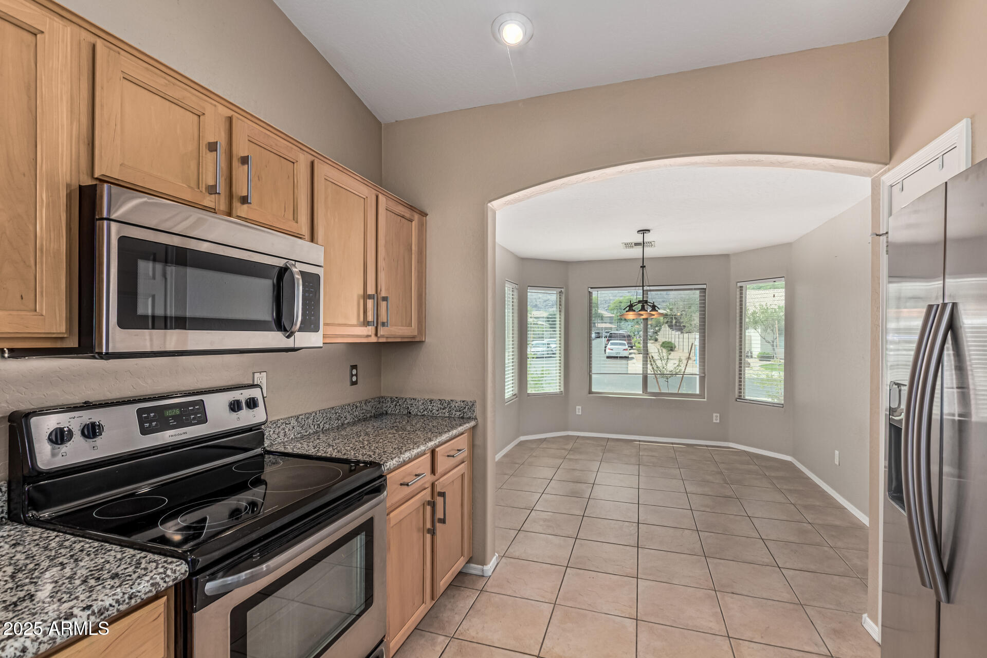 1634 East Harwell Road Phoenix, AZ 85042 - Photo 11 of 44 a kitchen with granite countertop a stove a sink and a microwave