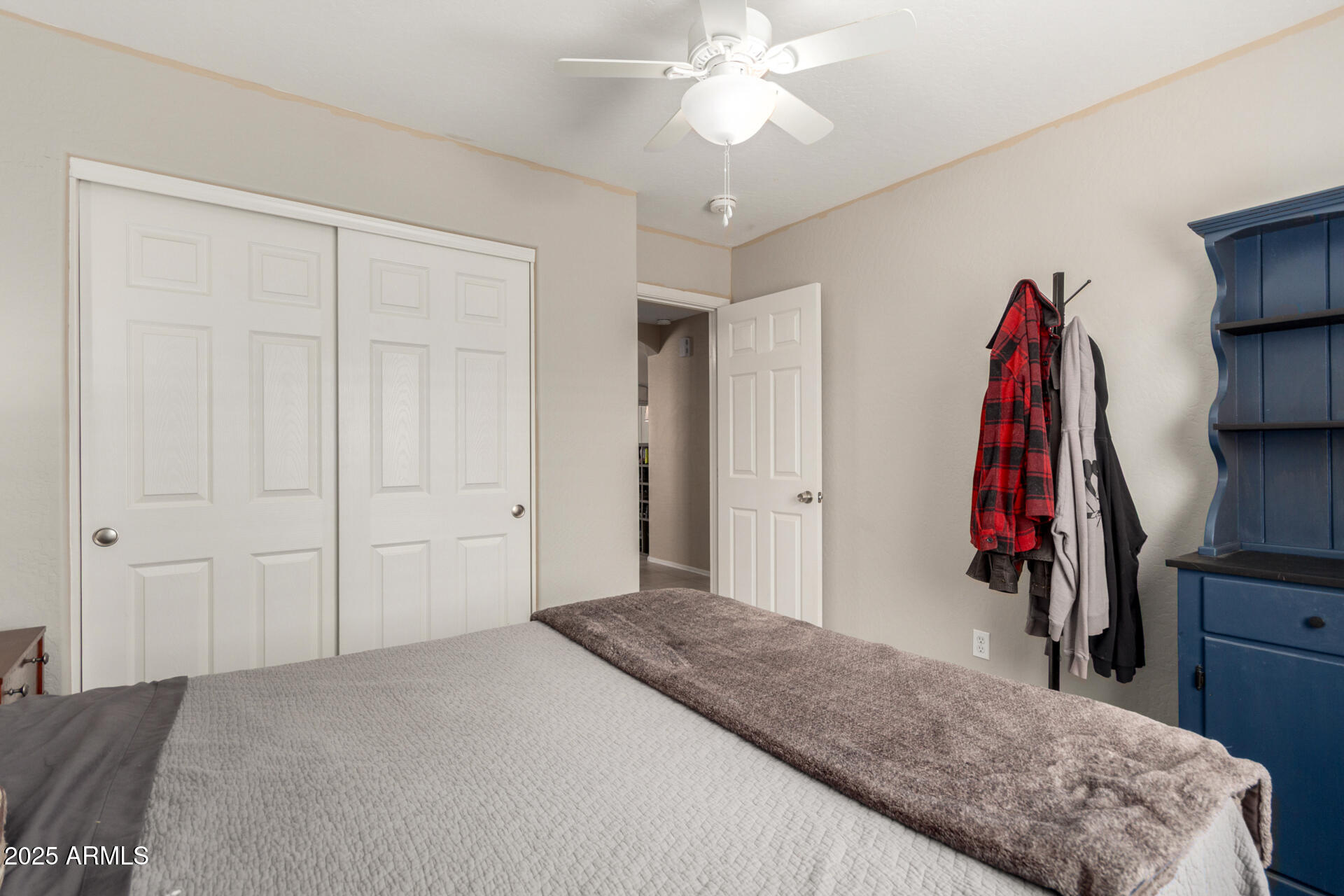 1634 East Harwell Road Phoenix, AZ 85042 - Photo 21 of 44 a bedroom with a bed and a chandelier