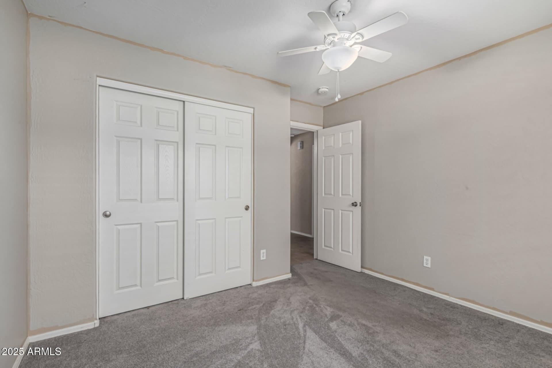 1634 East Harwell Road Phoenix, AZ 85042 - Photo 22 of 44 an empty room with closet and a ceiling fan