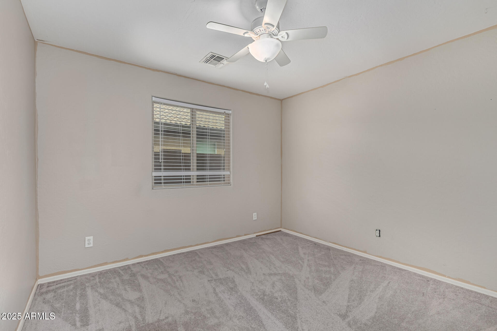 1634 East Harwell Road Phoenix, AZ 85042 - Photo 24 of 44 an empty room with a window and a fan
