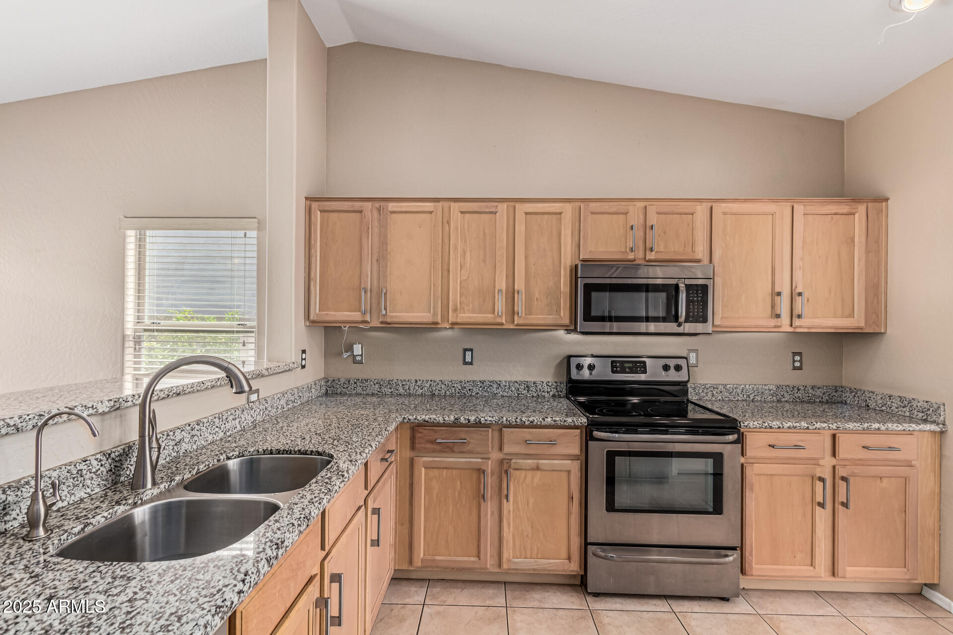 1634 East Harwell Road Phoenix, AZ 85042 - Photo 9 of 44 a kitchen with stainless steel appliances granite countertop a sink stove and microwave