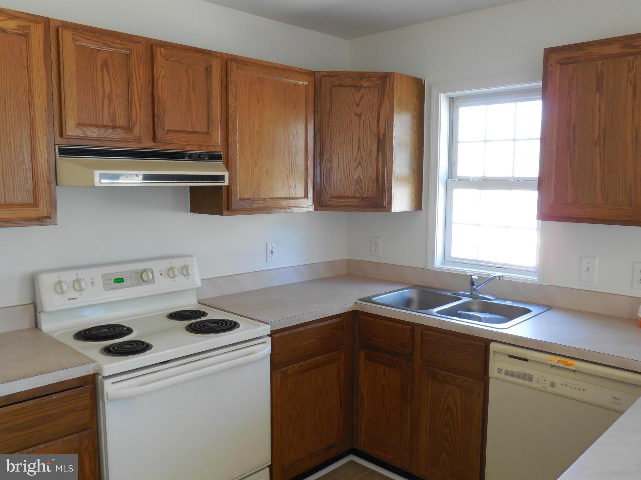 275 Cedar Ridge Drive Ruther Glen, VA 22546 - Photo 12 of 25 a kitchen with a cabinets and a stove top oven