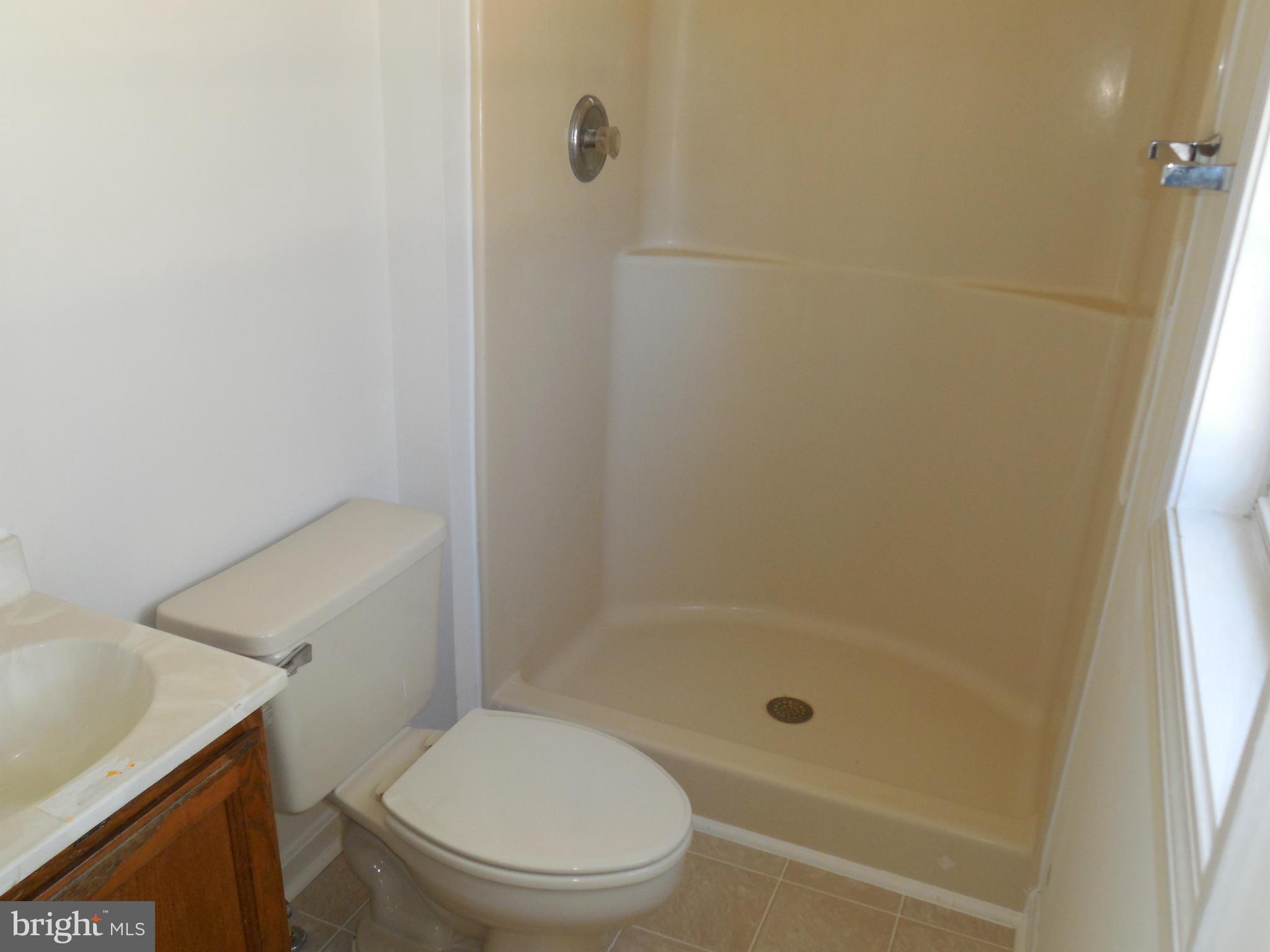 275 Cedar Ridge Drive Ruther Glen, VA 22546 - Photo 20 of 25 a bathroom with a shower and a toilet