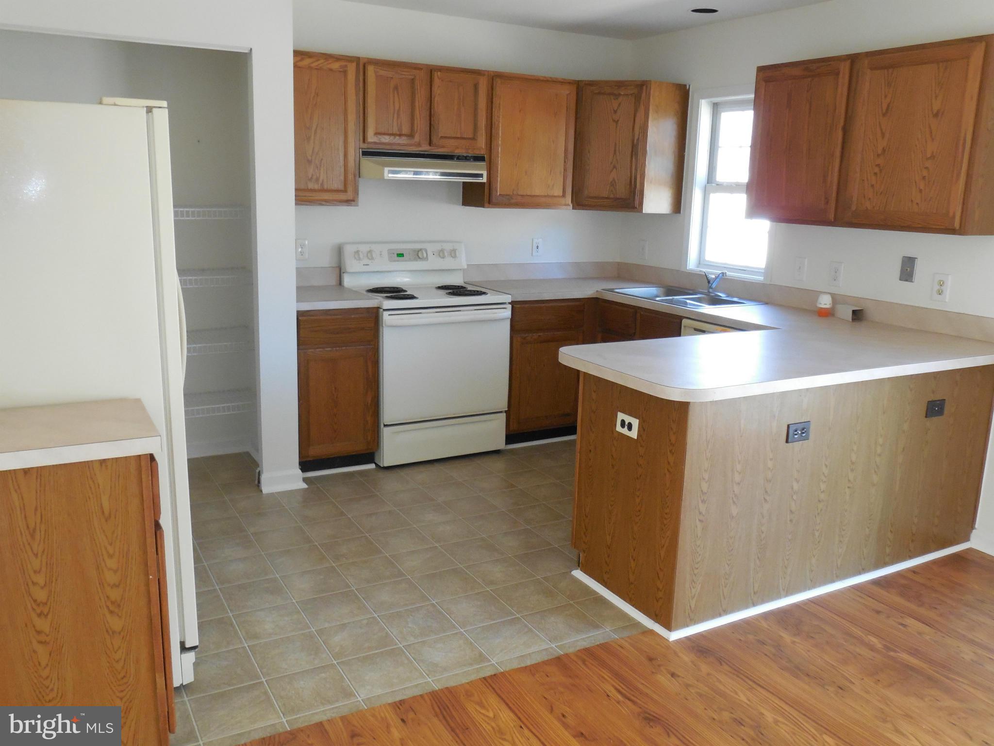 275 Cedar Ridge Drive Ruther Glen, VA 22546 - Photo 10 of 25 a kitchen with a sink a stove and cabinets