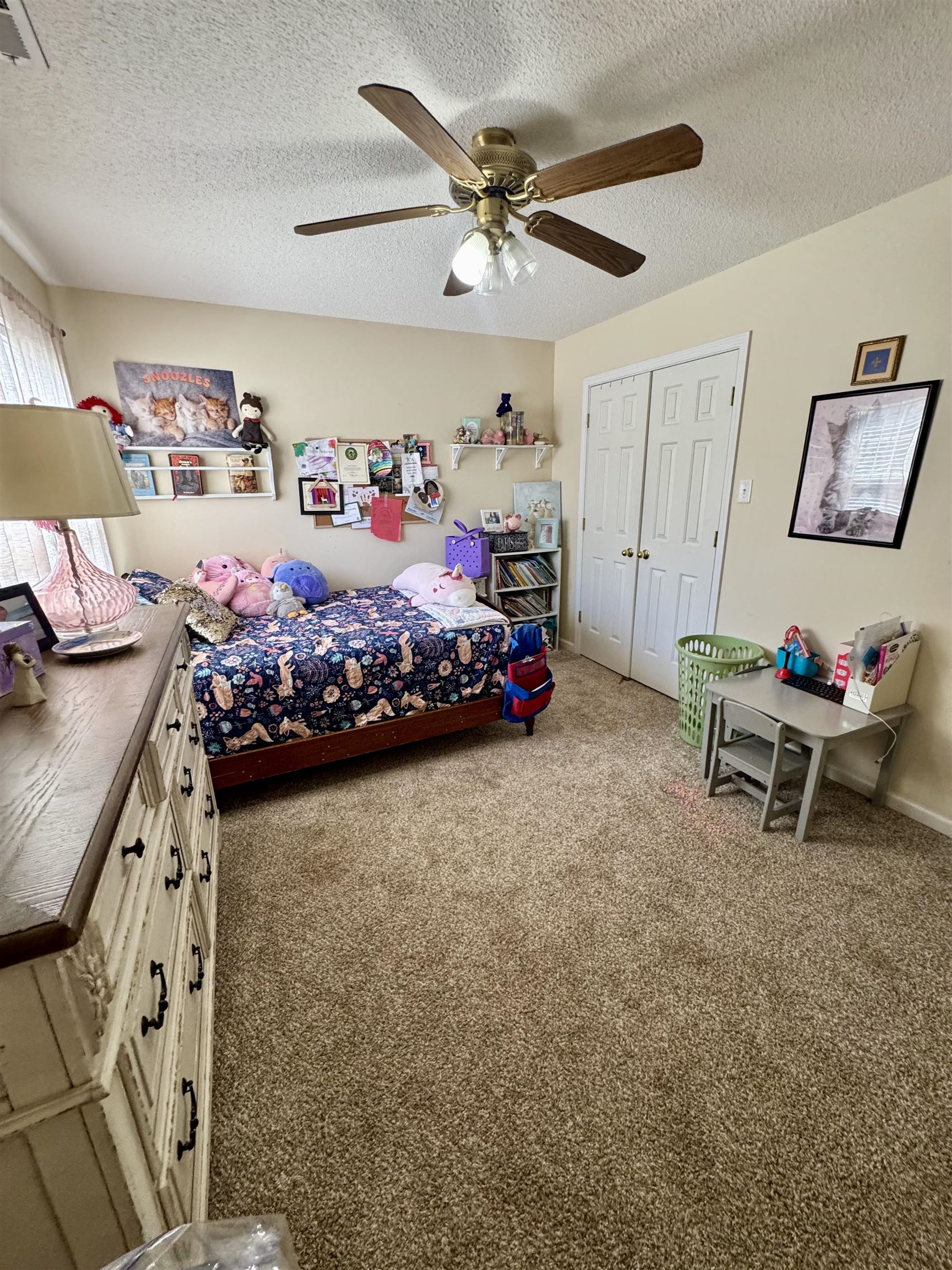 150 Westwood Circle Ripley, TN 38063 - Photo 18 of 28 Bedroom with a closet, light colored carpet, a textured ceiling, and a ceiling fan