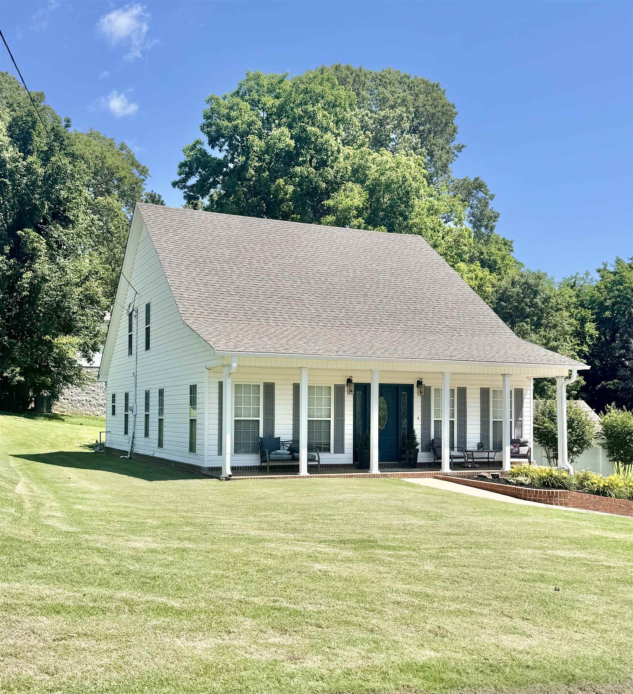 150 Westwood Circle Ripley, TN 38063 - Photo 2 of 28 View of front of property featuring covered porch, a front lawn, and roof with shingles