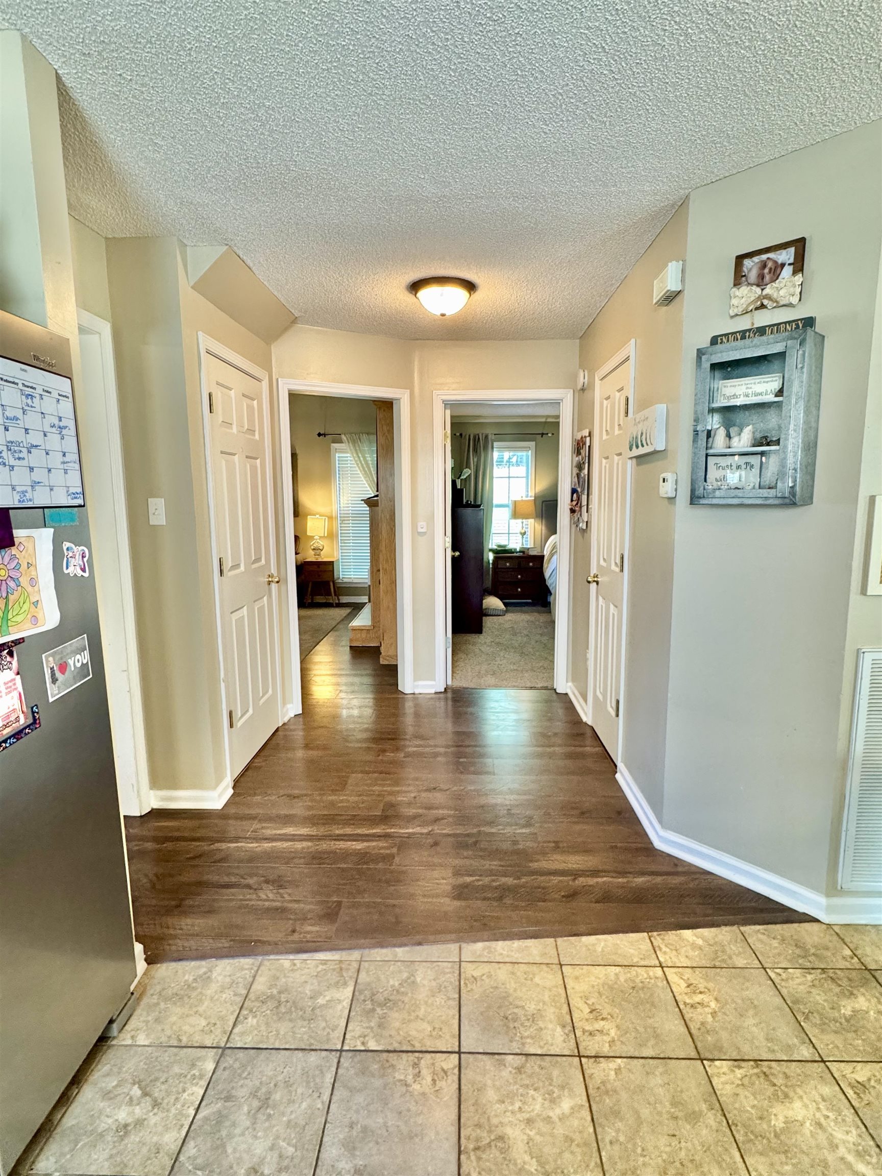 150 Westwood Circle Ripley, TN 38063 - Photo 6 of 28 Hallway featuring tile patterned floors, a textured ceiling, and baseboards