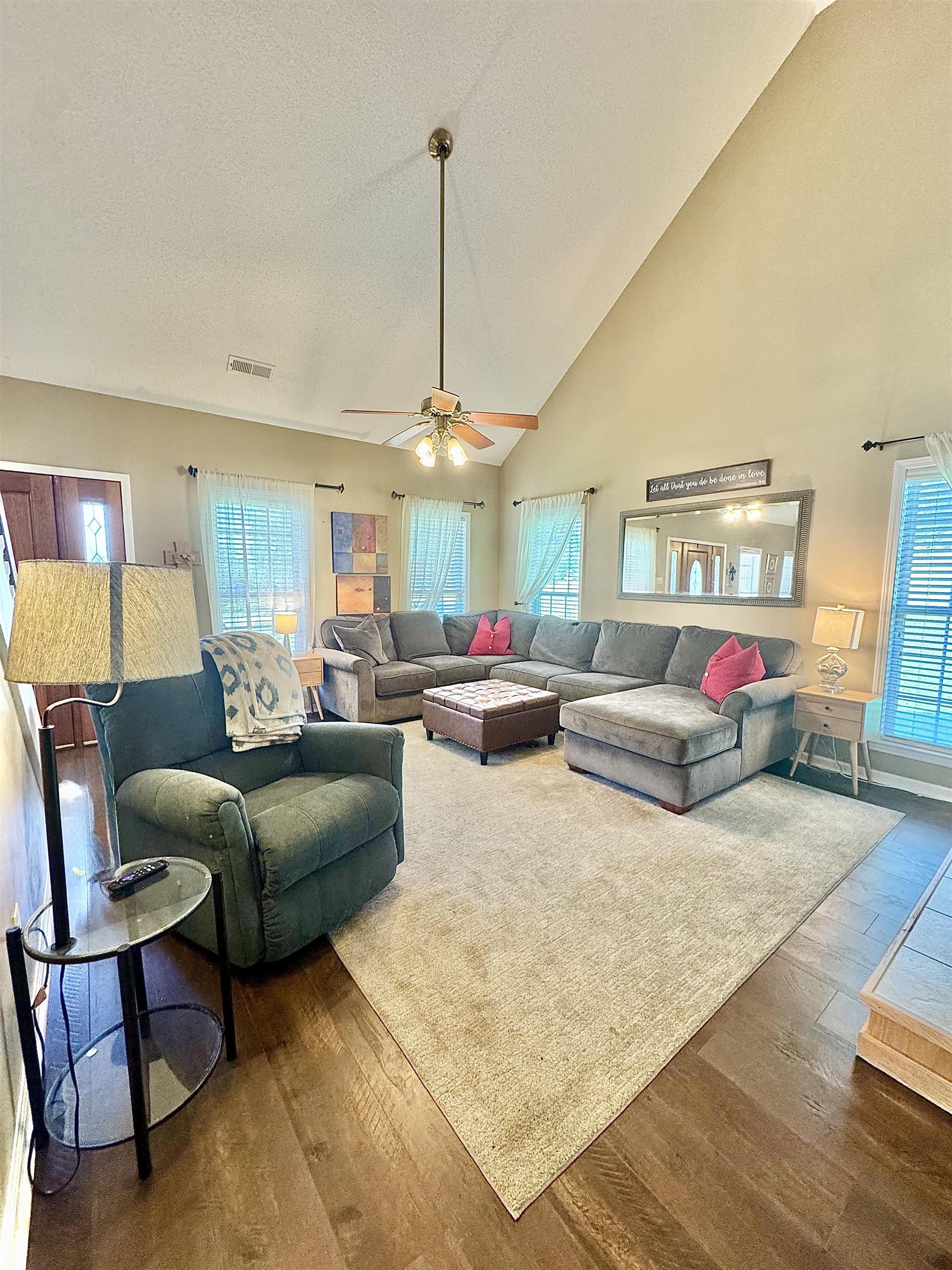 150 Westwood Circle Ripley, TN 38063 - Photo 7 of 28 Living room featuring wood finished floors, high vaulted ceiling, a ceiling fan, and a textured ceiling