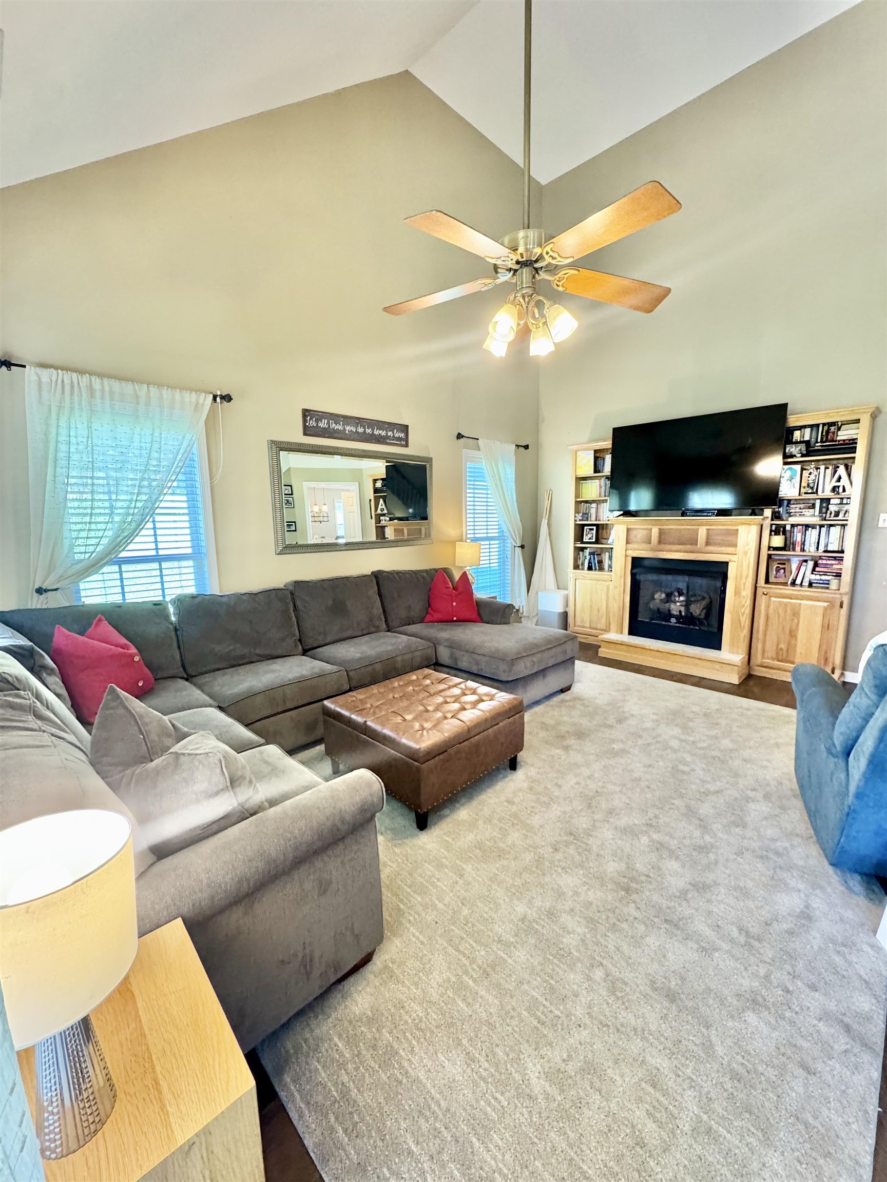 150 Westwood Circle Ripley, TN 38063 - Photo 8 of 28 Carpeted living room with high vaulted ceiling, a ceiling fan, and a glass covered fireplace