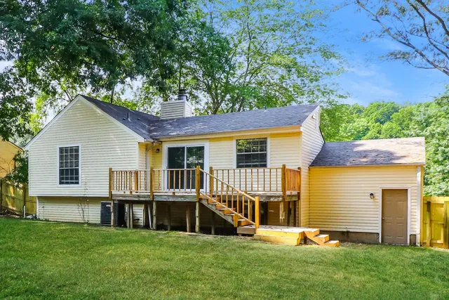 a view of a house with a yard and sitting area