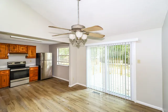 a view of a kitchen with a stove cabinets and wooden floor
