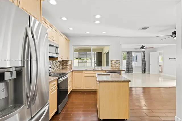 a view of a kitchen with a sink and a refrigerator