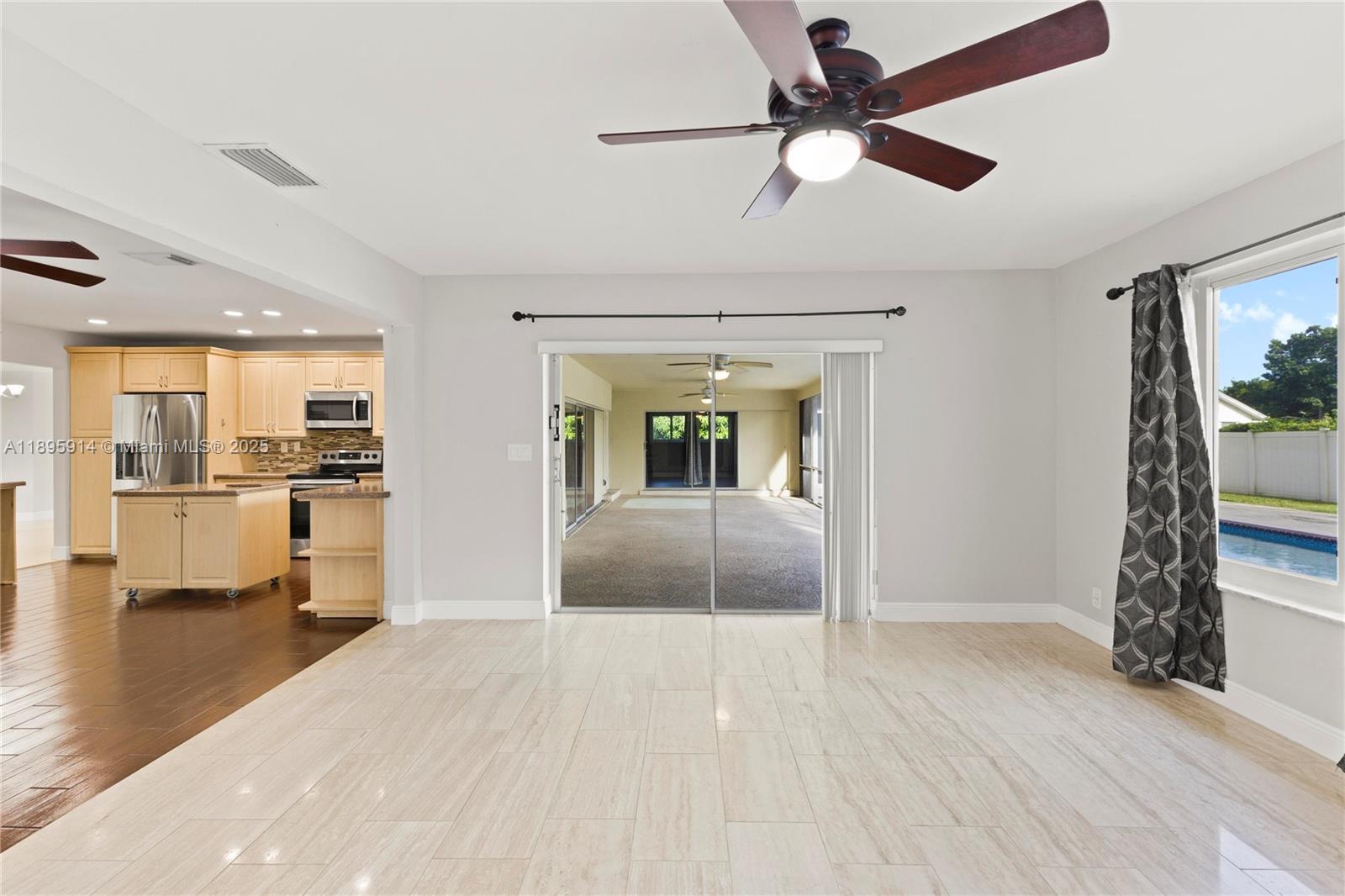 6150 Southwest 7th Street Plantation, FL 33317 - Photo 16 of 50 a view of an empty room and kitchen with wooden floor