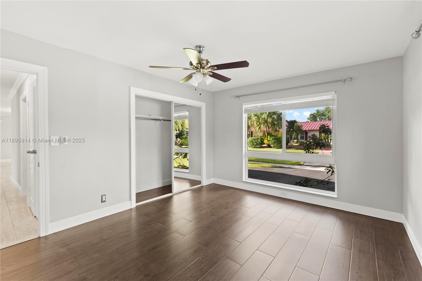 6150 Southwest 7th Street Plantation, FL 33317 - Photo 18 of 50 an empty room with wooden floor fan and windows