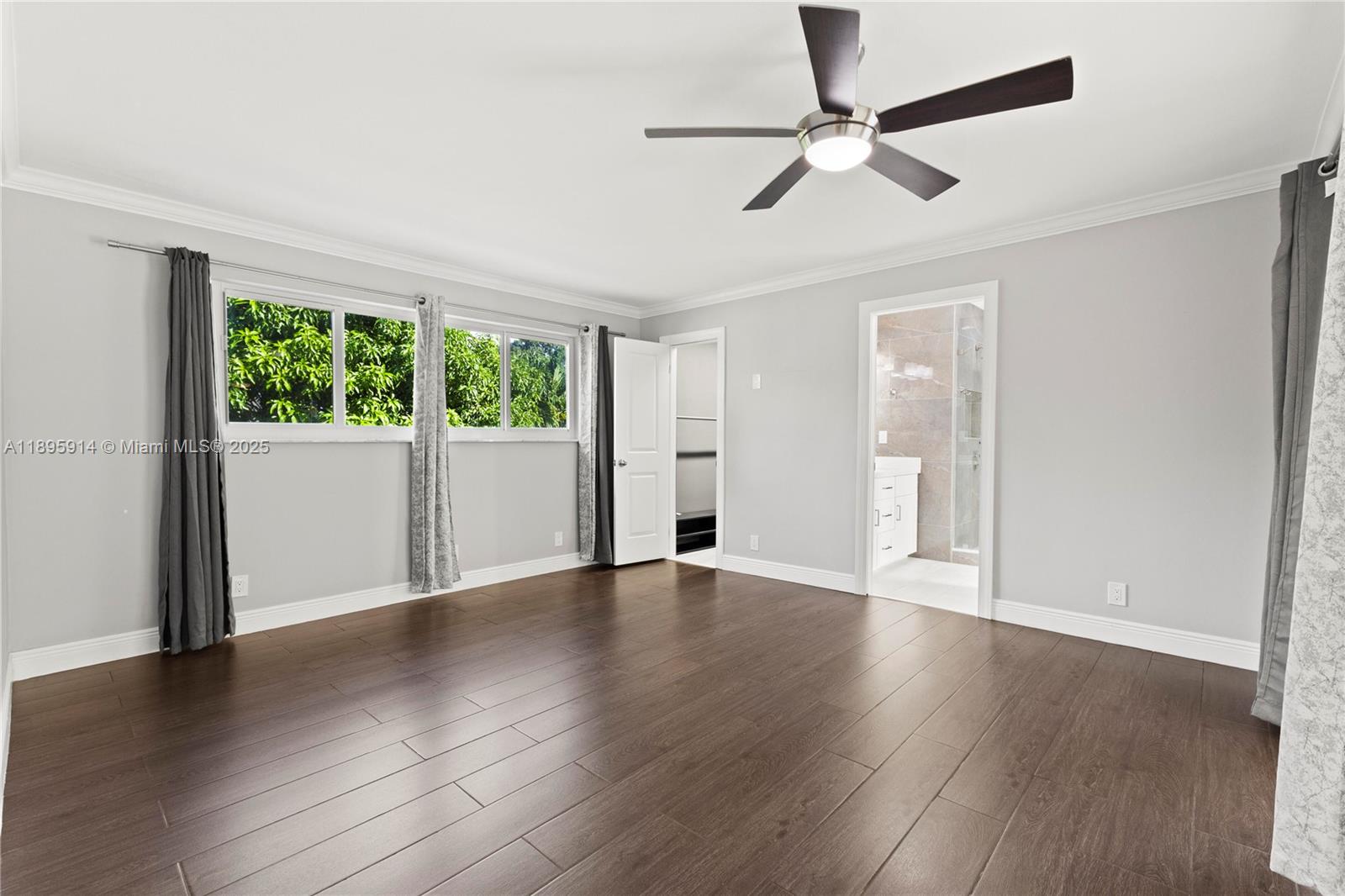 6150 Southwest 7th Street Plantation, FL 33317 - Photo 19 of 50 a view of an empty room with wooden floor and a window