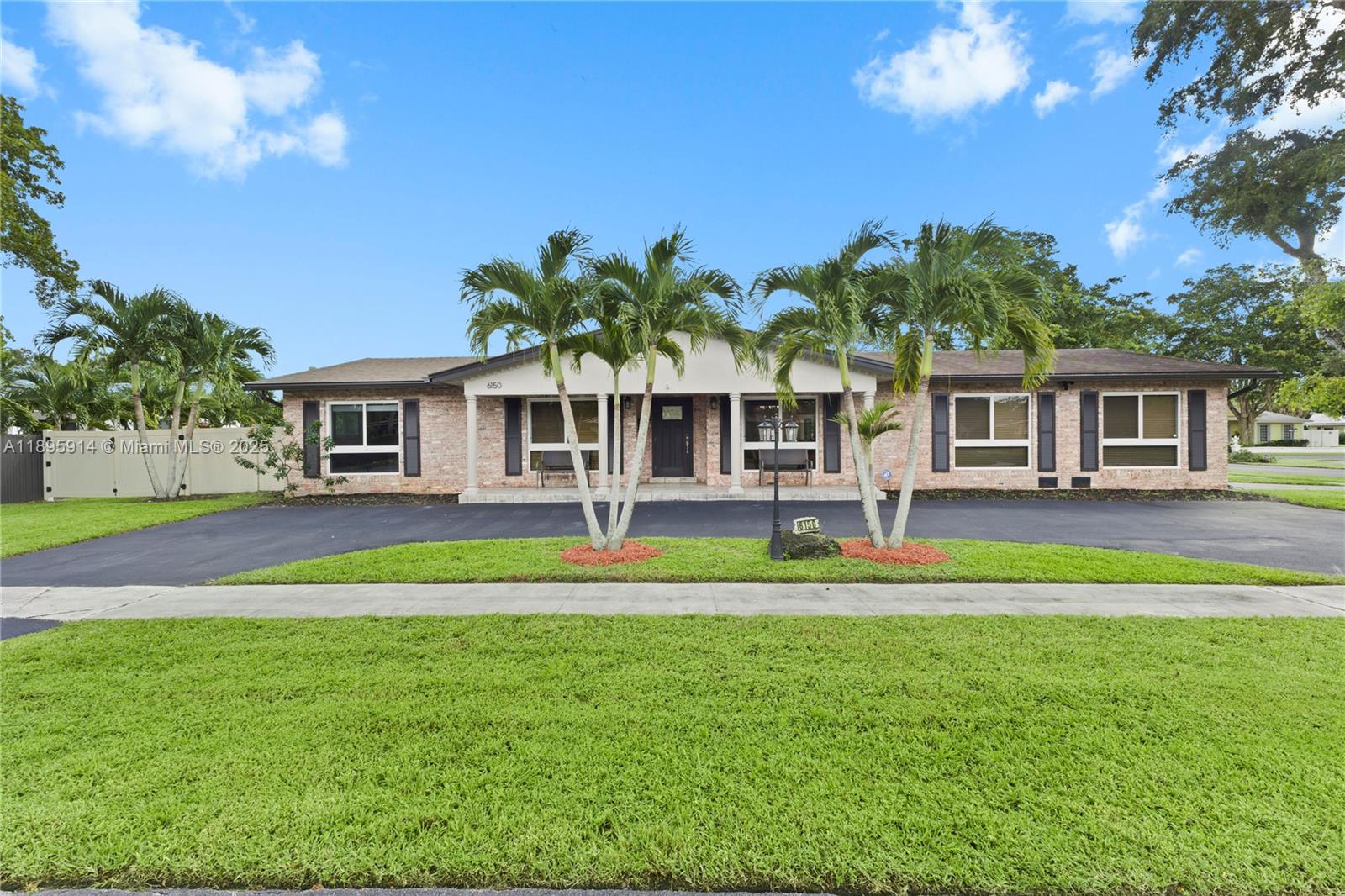 6150 Southwest 7th Street Plantation, FL 33317 - Photo 2 of 50 a front view of a house with a yard table and chairs