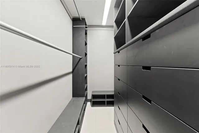 a bathroom with a sink vanity granite shower and a mirror