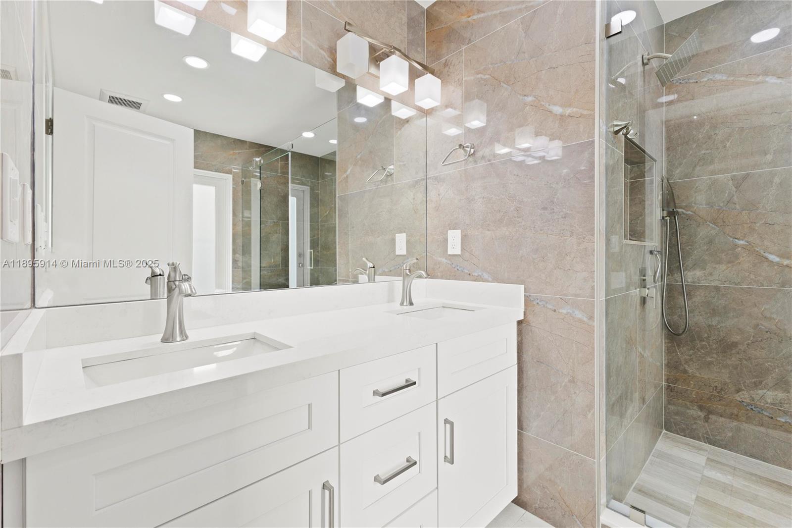 6150 Southwest 7th Street Plantation, FL 33317 - Photo 23 of 50 a bathroom with a sink vanity granite shower and a mirror