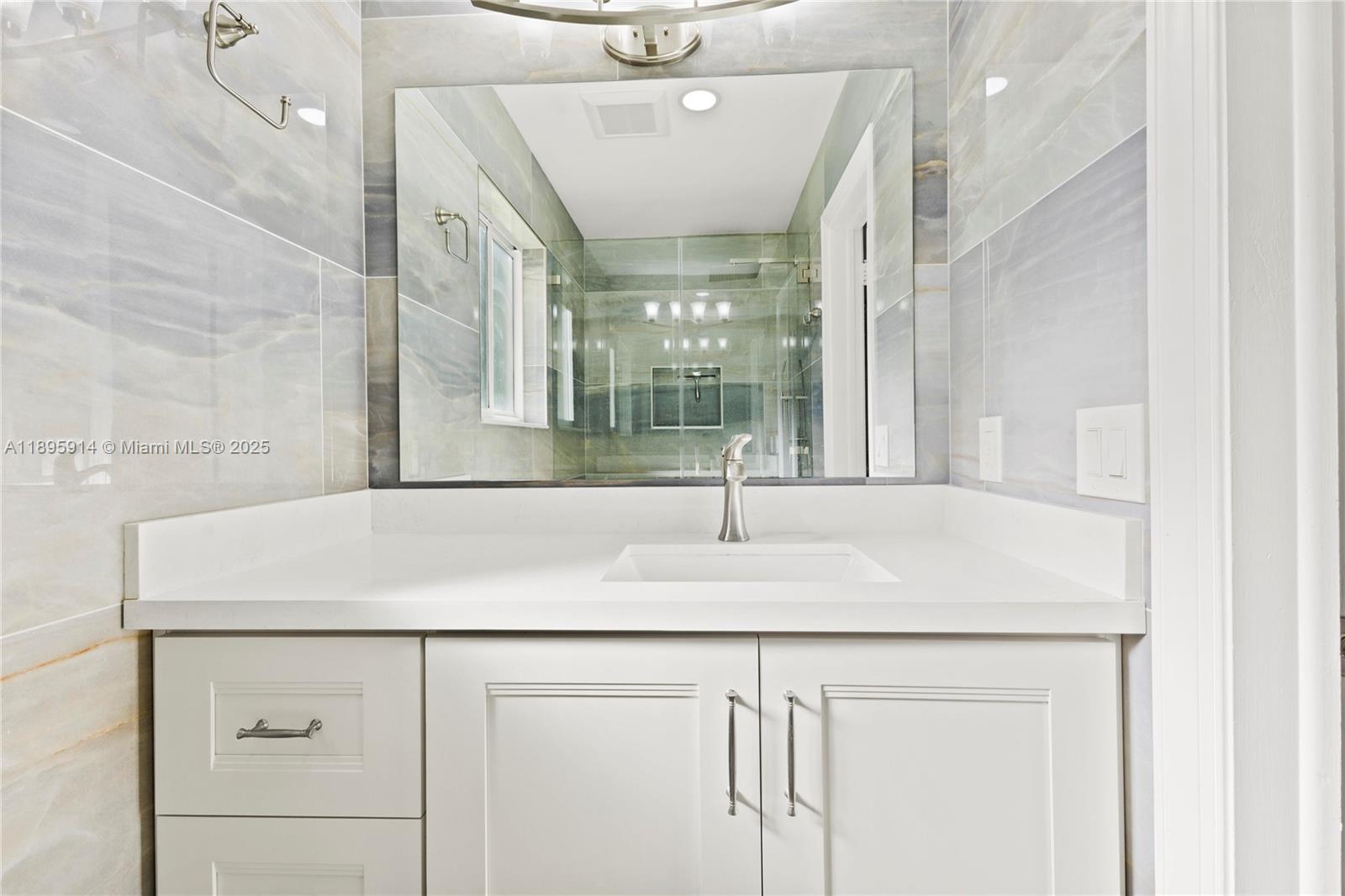 6150 Southwest 7th Street Plantation, FL 33317 - Photo 29 of 50 a bathroom with a sink and mirror