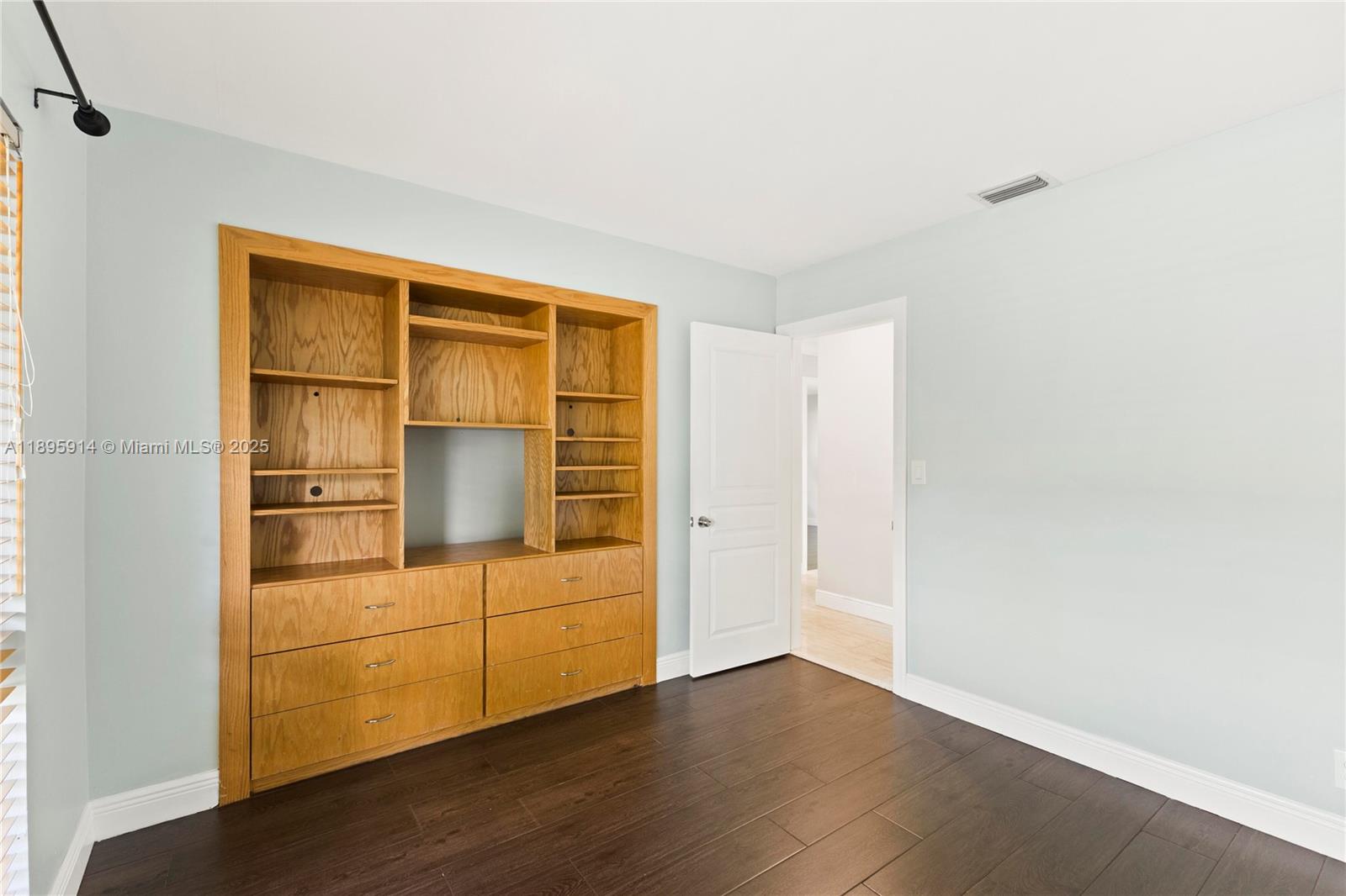 6150 Southwest 7th Street Plantation, FL 33317 - Photo 32 of 50 a view of an empty room with wooden floor and cabinet