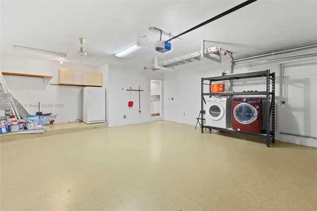 an empty room with floor to ceiling window and ceiling fan