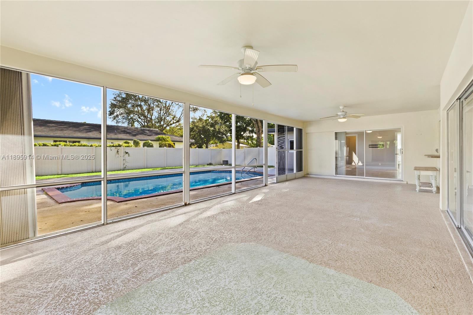 6150 Southwest 7th Street Plantation, FL 33317 - Photo 39 of 50 an empty room with floor to ceiling window and ceiling fan