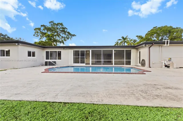 a view of house with backyard and garden