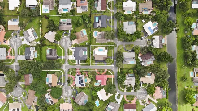 an aerial view of residential houses with city view