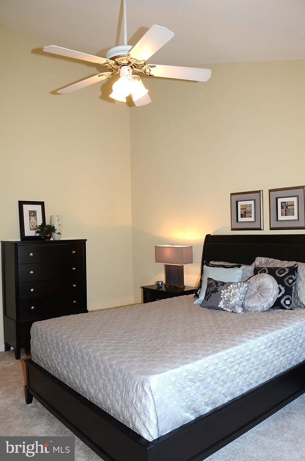 1267 Weatherstone Court Reston, VA 20194 - Photo 15 of 30 a bedroom with a bed and a chandelier