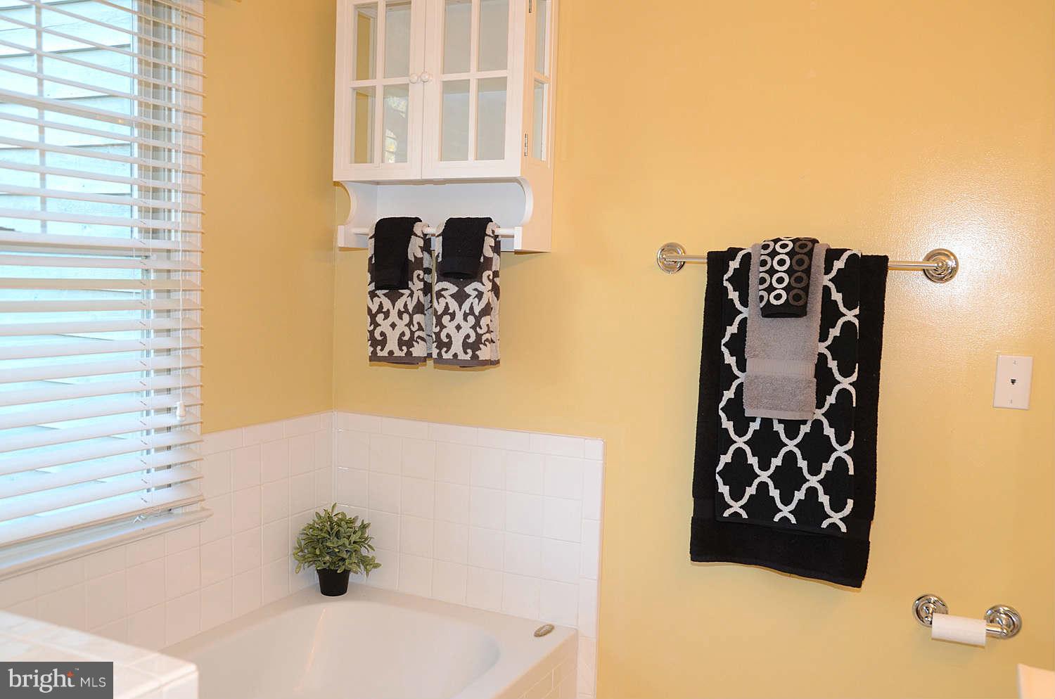 1267 Weatherstone Court Reston, VA 20194 - Photo 18 of 30 a bathroom with a bathtub and a shower
