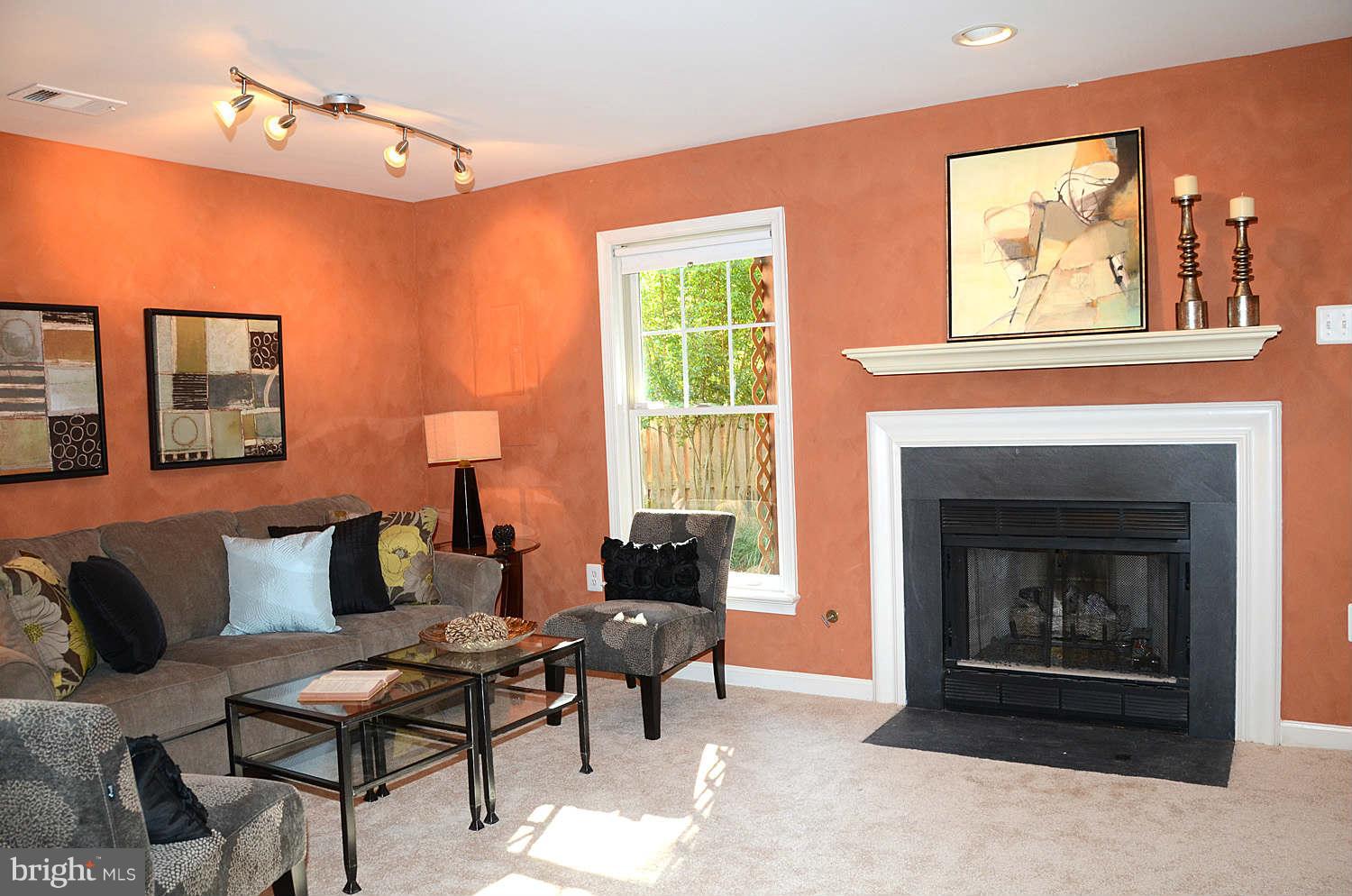 1267 Weatherstone Court Reston, VA 20194 - Photo 23 of 30 a living room with furniture and a fireplace
